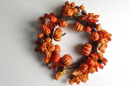 22072 - Autumn/Halloween wreath with an array of golden orange fruits and berries and a scattering of pine cones and bark. Measures  380mm diameter